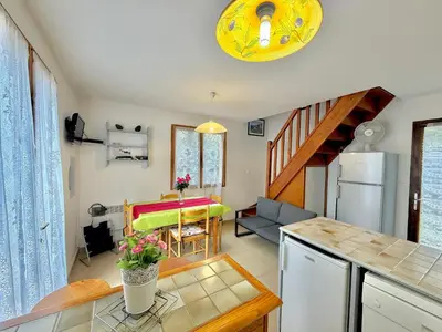a kitchen and a living room with a table at Mini villa Erbalunga, Santa Giulia in Porto-Vecchio