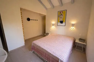 a bedroom with a bed in a room at Villa San Antonu, Santa Giulia in Porto-Vecchio