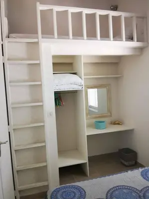 a white bunk bed in a room with a mirror at Villa San Antonu, Santa Giulia in Porto-Vecchio