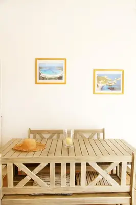 a wooden table with a candle on top of it at Villa Tizzano, Santa Giulia in Porto-Vecchio