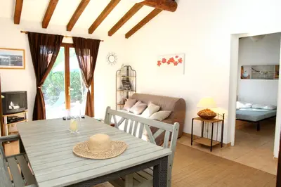 a living room with a table with a hat on it at Villa Tizzano, Santa Giulia in Porto-Vecchio