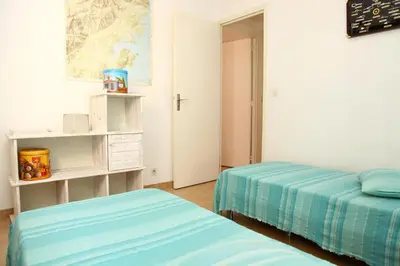 a bedroom with two beds in a room at Villa Tizzano, Santa Giulia in Porto-Vecchio
