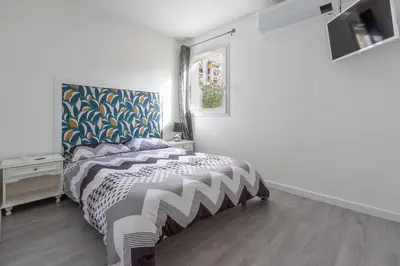 a bedroom with a bed and a window at Le Petra - Appt climatisé proche de la plage in Ajaccio