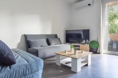 a living room with a couch and a coffee table at Le Petra - Appt climatisé proche de la plage in Ajaccio