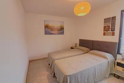 a living room with a table and chairs and a large window at Appartement Le Frassu PORTICCIO in Porticcio