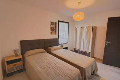 a dining room with a table and chairs on a balcony at Appartement Le Frassu PORTICCIO in Porticcio