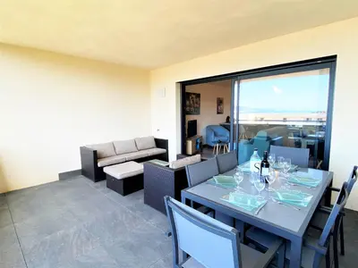 a living room with a table and a couch at Appartement Le Frassu PORTICCIO in Porticcio