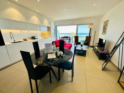a kitchen and living room with a table and chairs at 