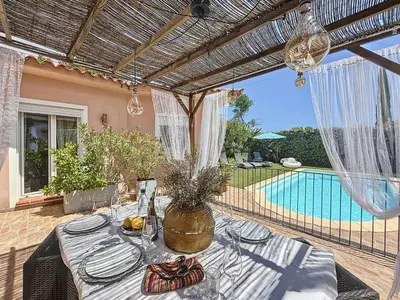 a patio with a table and a swimming pool at Villa Fautea Romance in Fautea