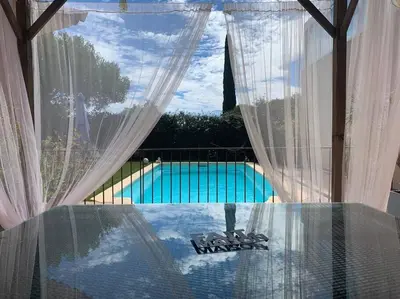 a view of a swimming pool through a window at Villa Fautea Romance in Fautea
