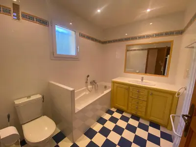 a bathroom with a toilet and a sink and a mirror at VILLA 5 pièces 8 couchages PORTICCIO in Porticcio