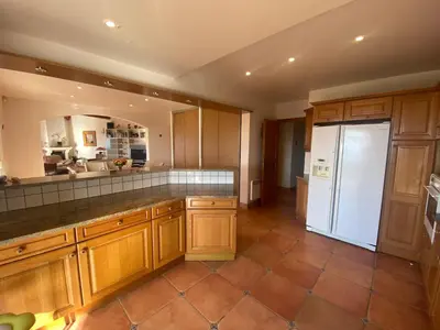 a kitchen with wooden cabinets and a white refrigerator at VILLA 5 pièces 8 couchages PORTICCIO in Porticcio