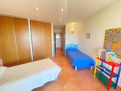 a bedroom with a bed and a book shelf at VILLA 5 pièces 8 couchages PORTICCIO in Porticcio