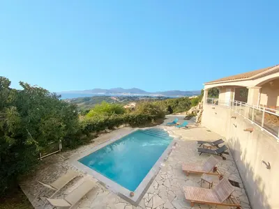 a villa with a swimming pool and a balcony at VILLA 5 pièces 8 couchages PORTICCIO in Porticcio