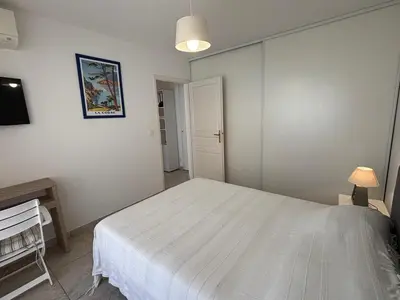 a bedroom with a large white bed in a room at Appartement Le Diana Sanguinaires Ajaccio in Ajaccio