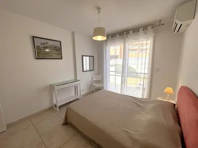 a bedroom with a large bed and a window at Appartement Le Diana Sanguinaires Ajaccio in Ajaccio