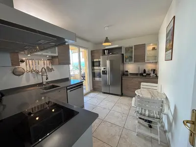 a kitchen with a sink and a refrigerator at Appartement Le Diana Sanguinaires Ajaccio in Ajaccio