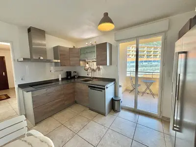 a kitchen with stainless steel appliances and a patio at Appartement Le Diana Sanguinaires Ajaccio in Ajaccio