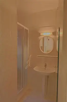 a bathroom with a sink and a mirror at Appartement Les Couchants PORTICCIO in Porticcio