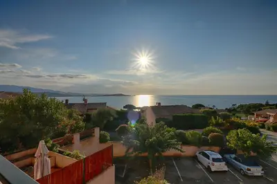 a view of the ocean from a house at Appartement Les Couchants PORTICCIO in Porticcio