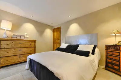a bedroom with a large bed and a dresser at casa teppe rosse in Aléria