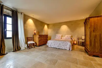a bedroom with a bed and a table and a window at casa teppe rosse in Aléria