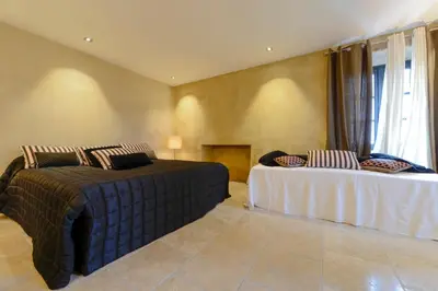 a bedroom with two beds and a window at casa teppe rosse in Aléria