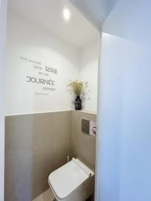 a bathroom with a toilet and a sign on the wall at Pretty cocoon with harbour view in Porto-Vecchio