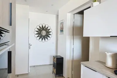 a kitchen with white walls and a refrigerator at Pretty cocoon with harbour view in Porto-Vecchio