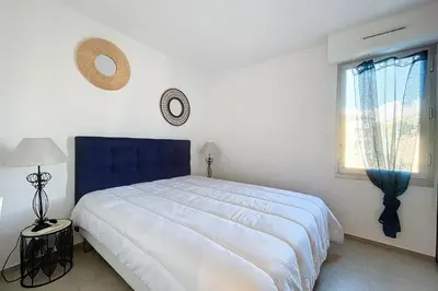 a bedroom with a large bed and a window at Pretty cocoon with harbour view in Porto-Vecchio
