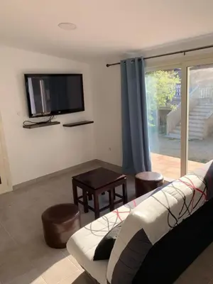 a living room with a couch and a flat screen tv at U FILANCIU in Olmeto