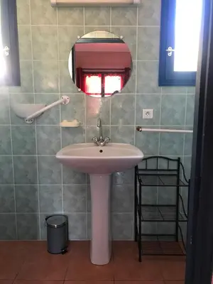 a bathroom with a white sink and a mirror at U FILANCIU in Olmeto