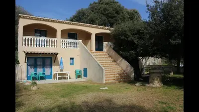 a house with a staircase in front of it at U FILANCIU in Olmeto