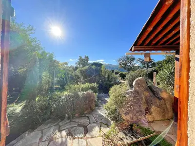 a view of a garden from a window of a house at Villa Argentella, Santa Giulia in Porto-Vecchio