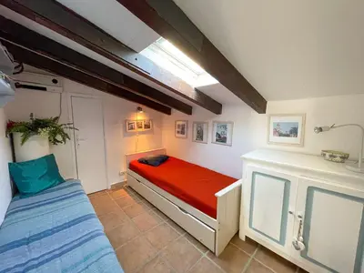 a small room with a bed and a window at Villa Argentella, Santa Giulia in Porto-Vecchio