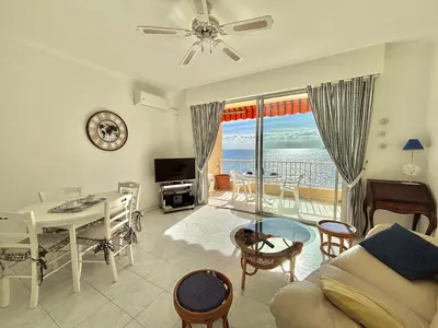 a living room with a view of the ocean at Studio Corse Azur pieds dans l'eau Ajaccio in Ajaccio