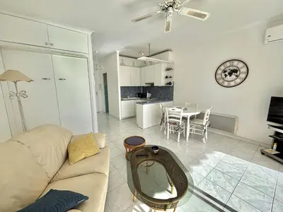 a living room with a couch and a table at Studio Corse Azur pieds dans l'eau Ajaccio in Ajaccio