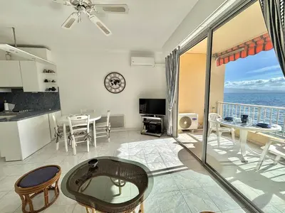 a kitchen and living room with a view of the ocean at Studio Corse Azur pieds dans l'eau Ajaccio in Ajaccio