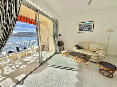 a living room with a couch and a table at Studio Corse Azur pieds dans l'eau Ajaccio in Ajaccio