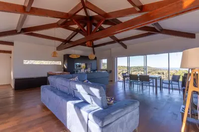 a living room with a blue couch and a table at L'Orangeraie de Portigliolo - Vue mer 4 chambres in Coti-Chiavari