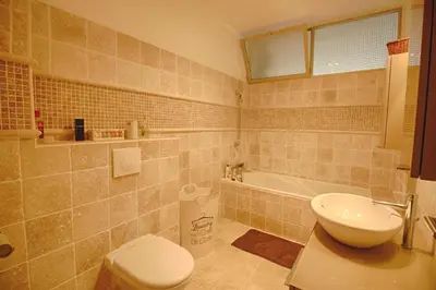 a bathroom with a toilet and a sink and a tub at Appartement Le Kent centre ville AJACCIO in Ajaccio