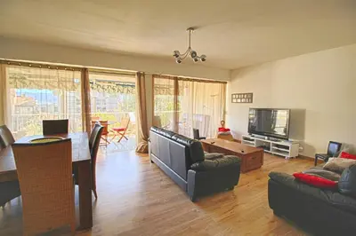a living room with a couch and a dining room at Appartement Le Kent centre ville AJACCIO in Ajaccio