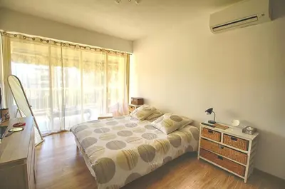 a bedroom with a bed and a large window at Appartement Le Kent centre ville AJACCIO in Ajaccio