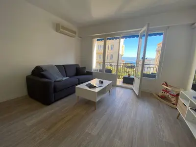 a living room with a couch and a table at Appartement Sacré Coeur 6 couchages AJACCIO in Ajaccio