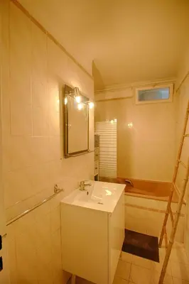 a bathroom with a sink and a tub and a mirror at Appartement Eugénie centre-ville Ajaccio in Ajaccio