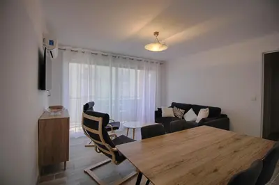 a living room with a wooden table and chairs at Appartement Eugénie centre-ville Ajaccio in Ajaccio