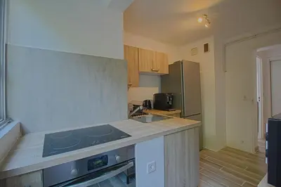 a kitchen with a sink and a stove top oven at Appartement Eugénie centre-ville Ajaccio in Ajaccio