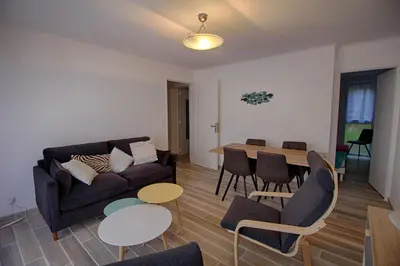 a living room with a couch and a table and chairs at Appartement Eugénie centre-ville Ajaccio in Ajaccio