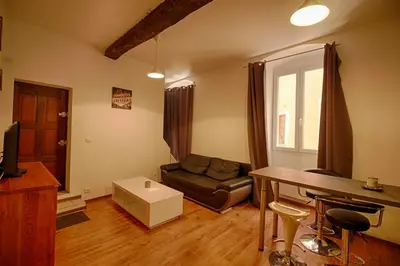 a living room with a couch and a table at Studio Conventionnel Chiappe Vieille ville Ajaccio in Ajaccio