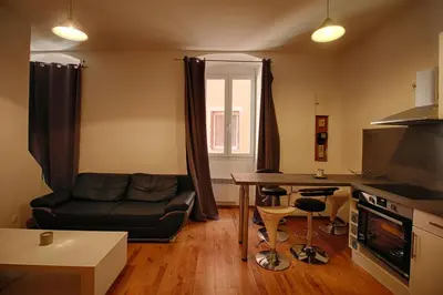 a living room with a couch and a table at Studio Conventionnel Chiappe Vieille ville Ajaccio in Ajaccio